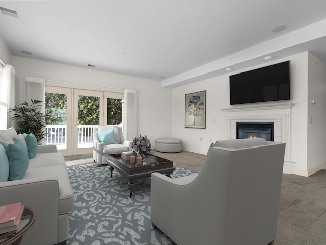 living area featuring visible vents, carpet flooring, baseboards, and a glass covered fireplace