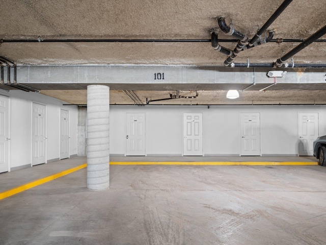 parking deck featuring a garage door opener and baseboards