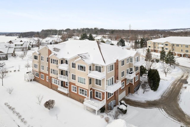 snowy aerial view featuring a residential view