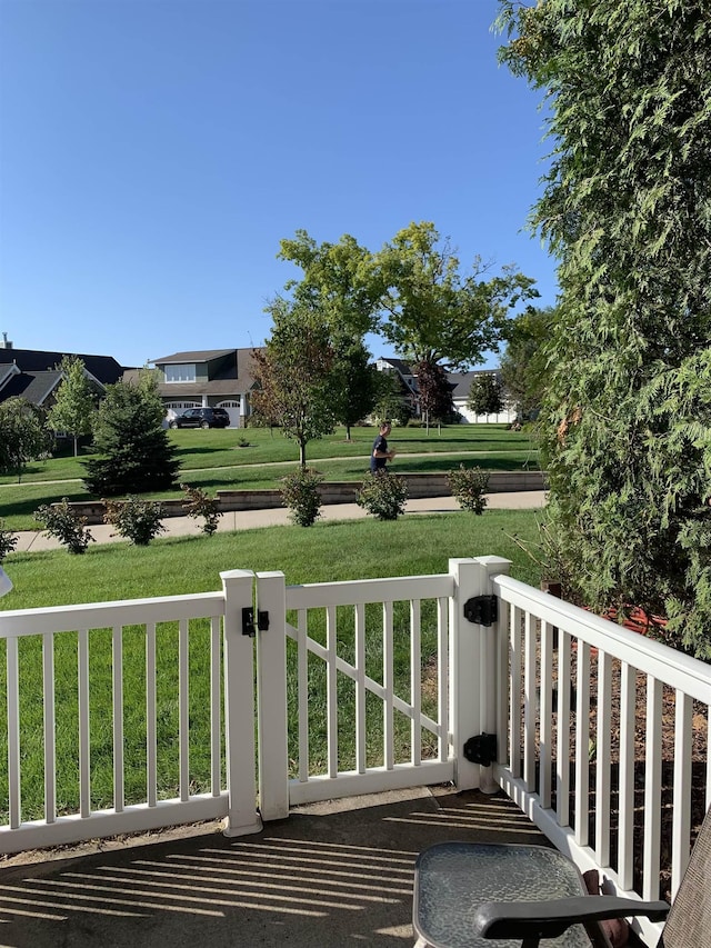 wooden terrace featuring a yard and covered porch