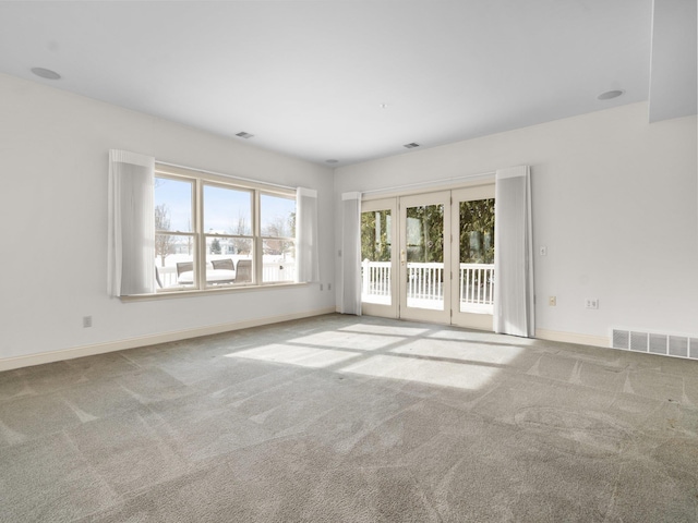 unfurnished room featuring visible vents, carpet flooring, and baseboards