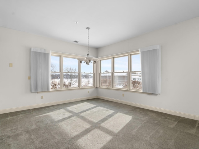 unfurnished room featuring visible vents, baseboards, an inviting chandelier, and carpet flooring