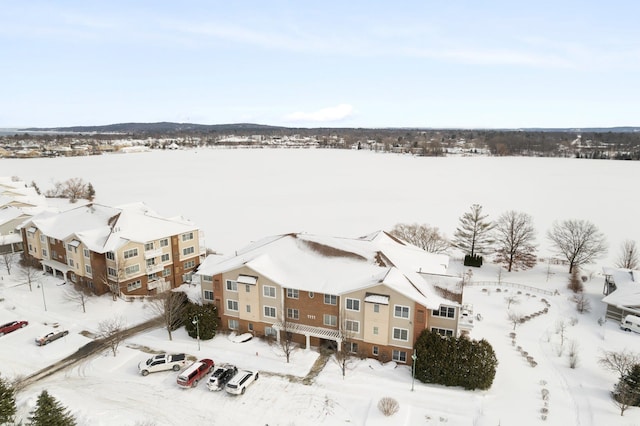 snowy aerial view with a residential view