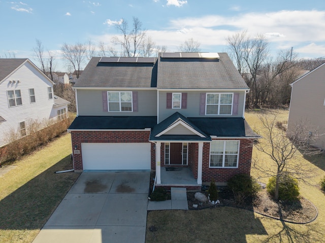 view of front of property with a front lawn, concrete driveway, an attached garage, brick siding, and solar panels