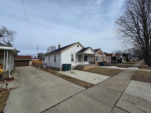 view of front of property featuring an outbuilding, covered porch, and a chimney