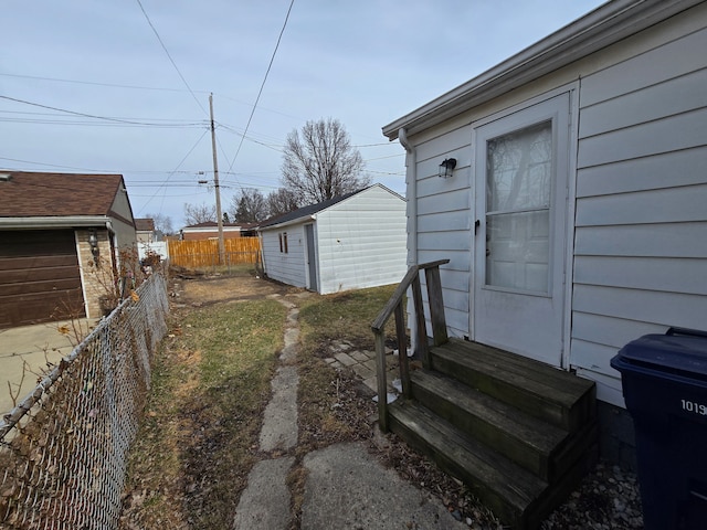 view of yard with entry steps and fence