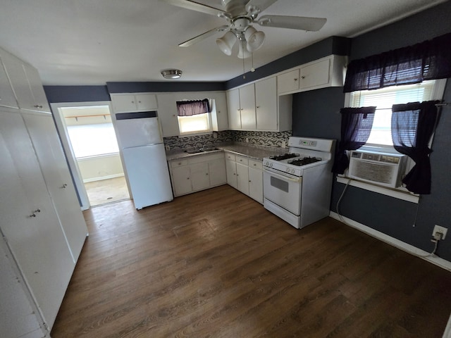 kitchen with white appliances, white cabinets, plenty of natural light, and dark wood-style floors