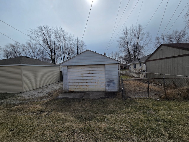 view of outdoor structure featuring an outbuilding and fence