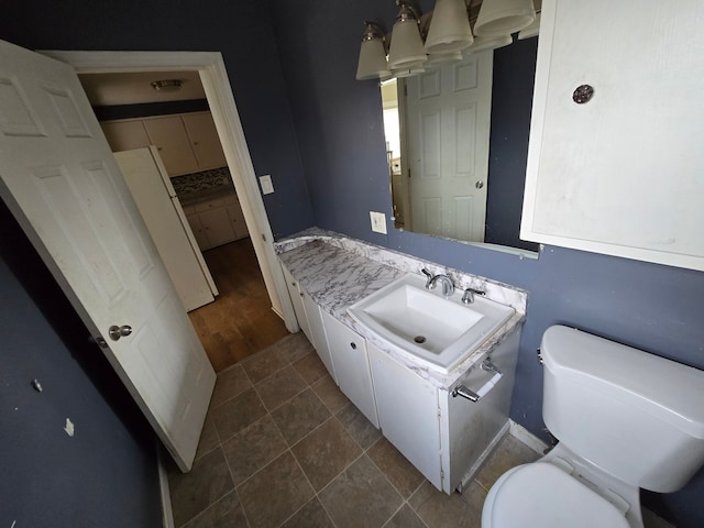 half bathroom featuring toilet and vanity