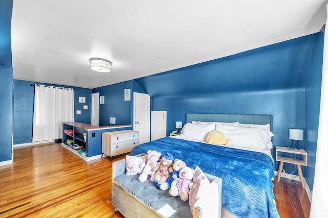 bedroom featuring wood finished floors and baseboards