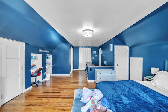 bedroom with baseboards and wood finished floors