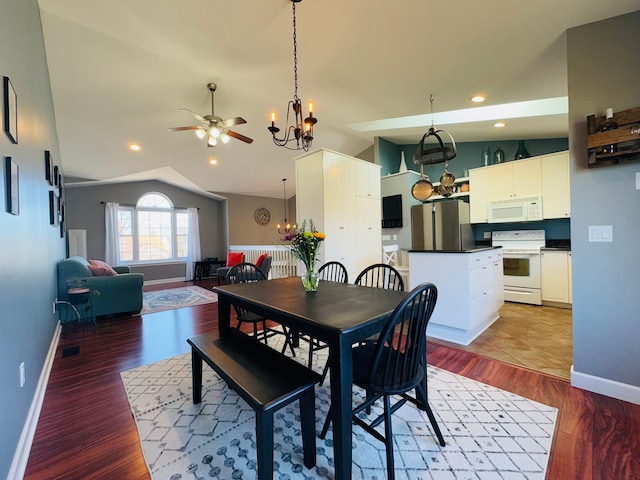 dining space with vaulted ceiling, recessed lighting, wood finished floors, and baseboards