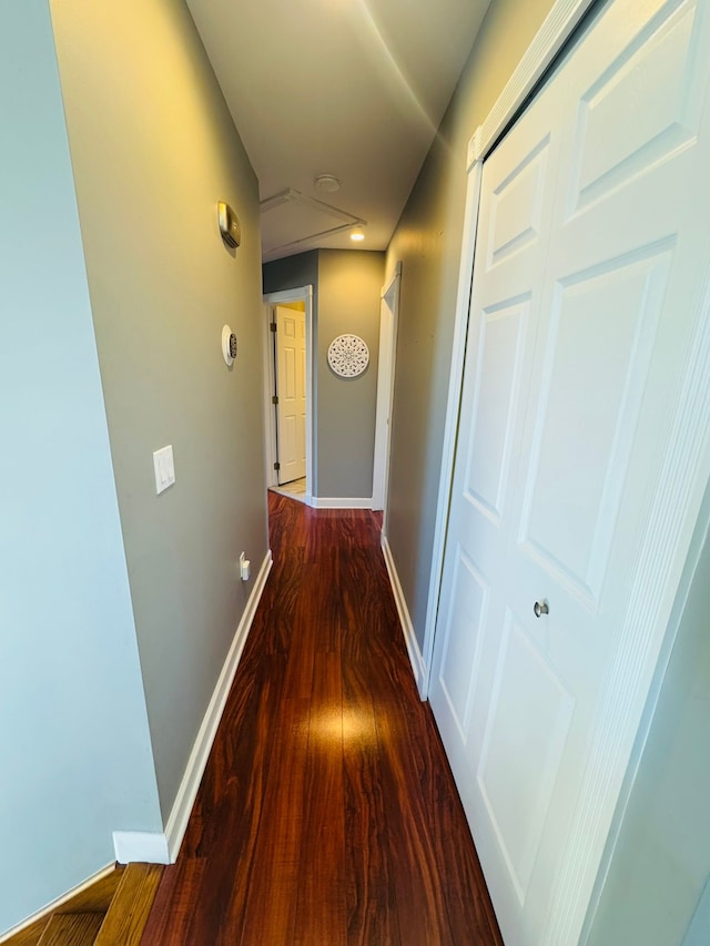 hall featuring wood finished floors and baseboards