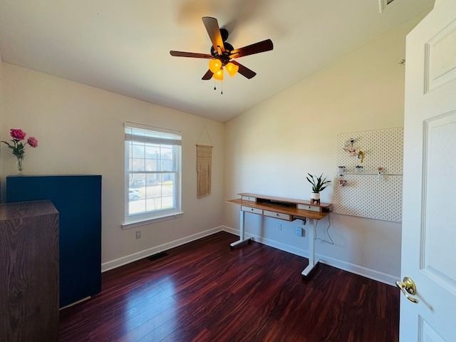 unfurnished office with visible vents, lofted ceiling, a ceiling fan, wood finished floors, and baseboards