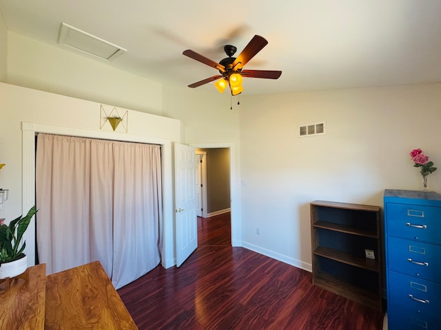 unfurnished bedroom featuring visible vents, baseboards, attic access, vaulted ceiling, and wood finished floors