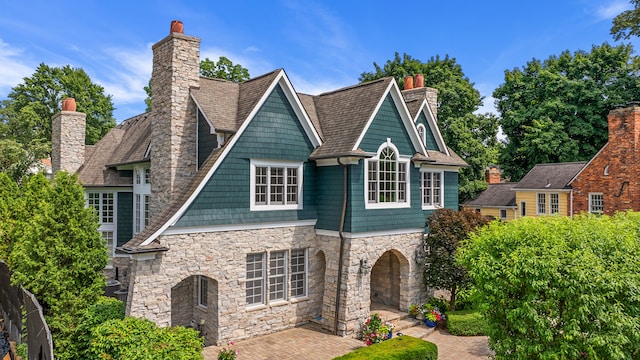 view of front of house with a chimney and a patio area