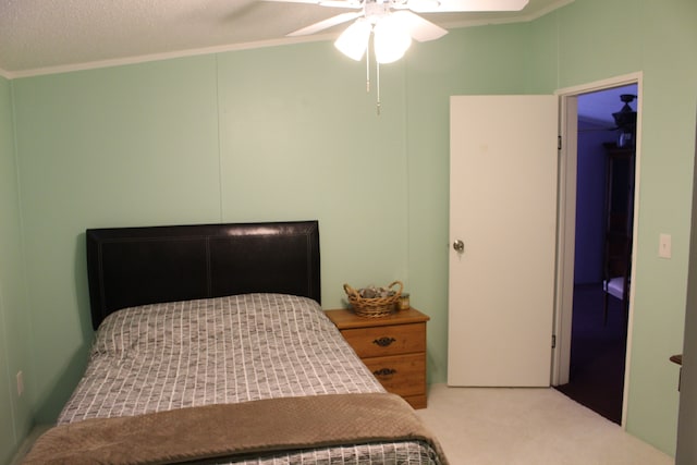 bedroom with carpet, ornamental molding, a ceiling fan, and a textured ceiling