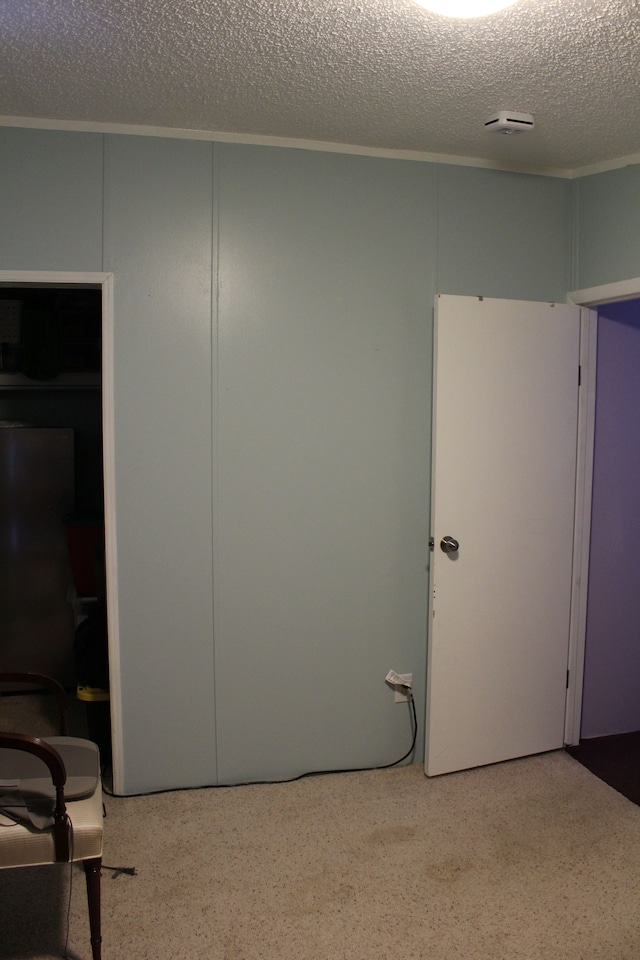 empty room featuring speckled floor and a textured ceiling