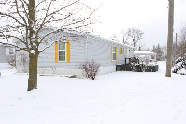 snow covered property featuring a deck