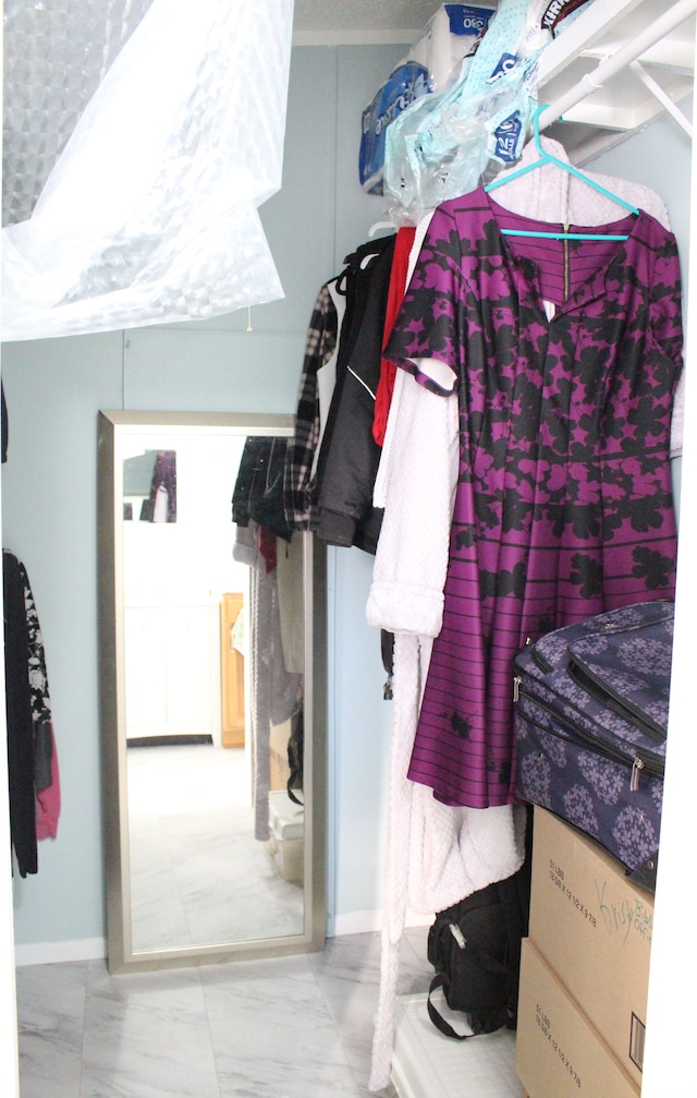 spacious closet with marble finish floor