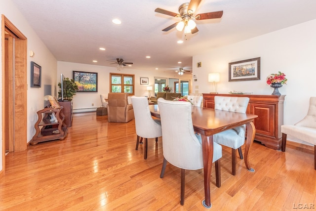 dining room featuring recessed lighting, light wood-style flooring, and a baseboard heating unit