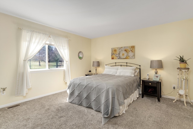 bedroom with carpet flooring, baseboards, and visible vents