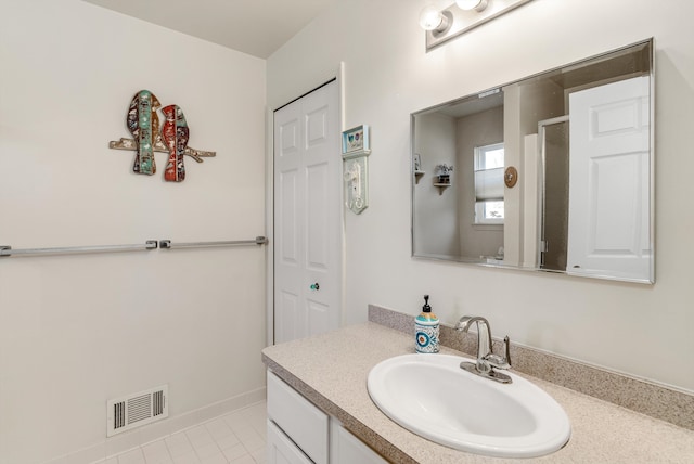 bathroom with vanity, visible vents, and tile patterned flooring