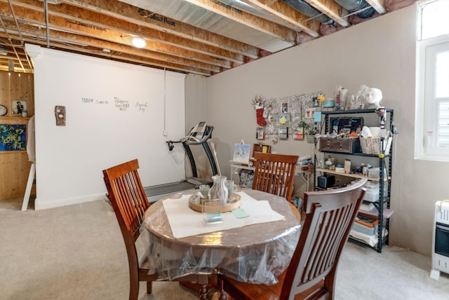 dining space featuring light carpet