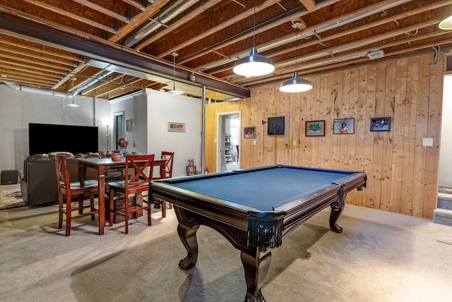 playroom with carpet and wood walls