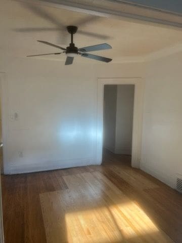 unfurnished room featuring a ceiling fan and wood finished floors