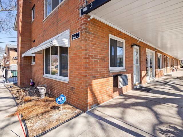 view of side of property featuring brick siding