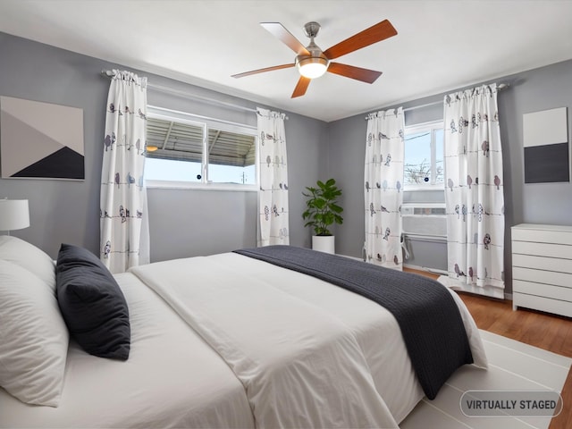 bedroom with wood finished floors and ceiling fan