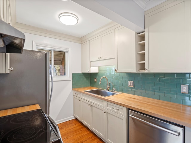 kitchen with a sink, wood counters, open shelves, ventilation hood, and appliances with stainless steel finishes