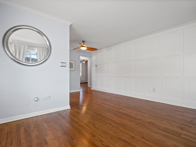 spare room featuring baseboards, wood finished floors, a ceiling fan, and crown molding