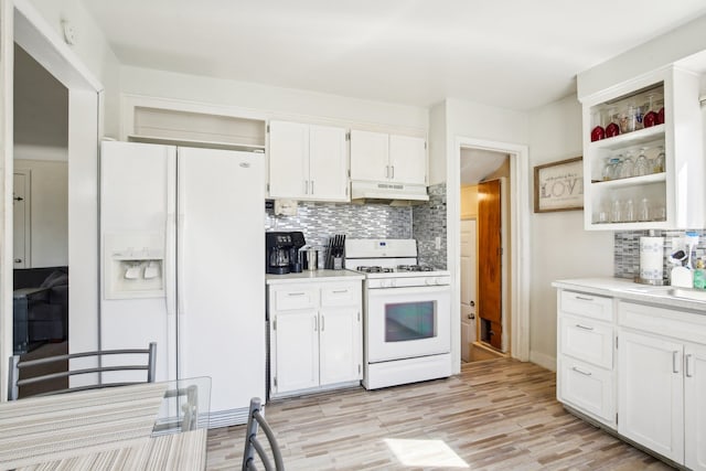 kitchen featuring under cabinet range hood, light countertops, decorative backsplash, white appliances, and white cabinetry