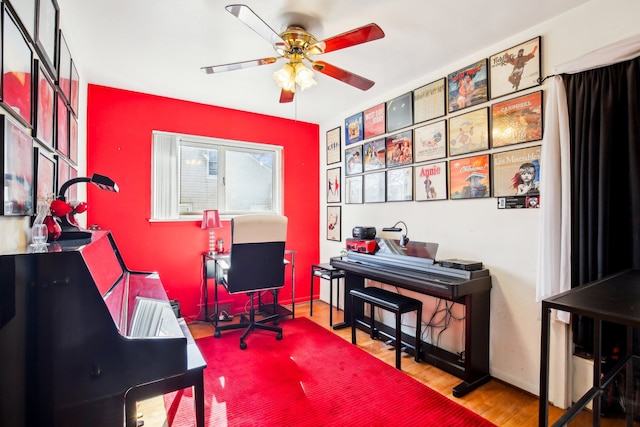 home office with baseboards, ceiling fan, and wood finished floors