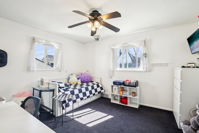 carpeted bedroom with a ceiling fan and baseboards