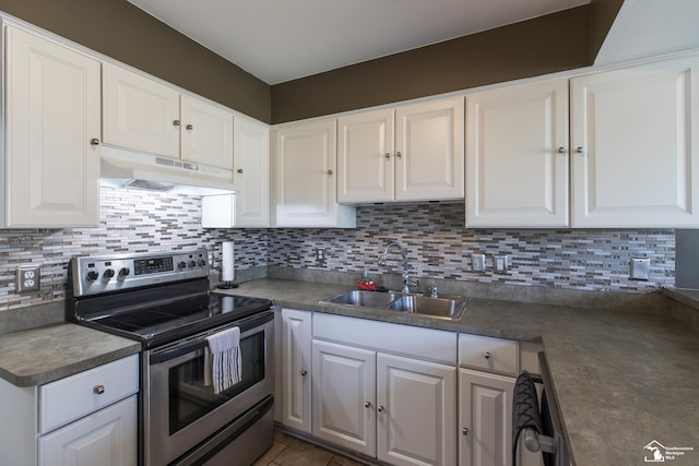 kitchen featuring under cabinet range hood, a sink, appliances with stainless steel finishes, white cabinets, and decorative backsplash