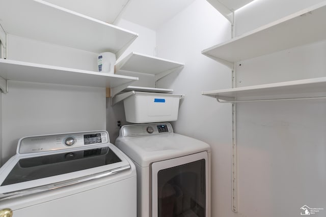 laundry room with separate washer and dryer and laundry area