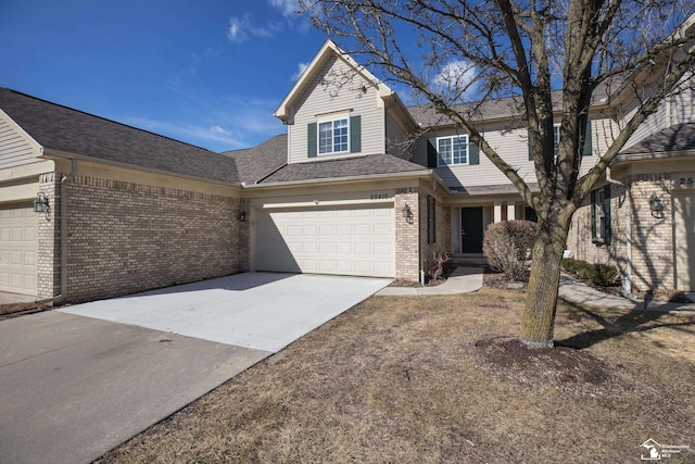 view of front of property featuring an attached garage, brick siding, driveway, and roof with shingles