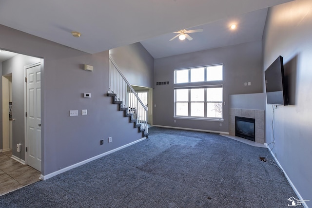 unfurnished living room with visible vents, carpet flooring, a fireplace, baseboards, and stairs