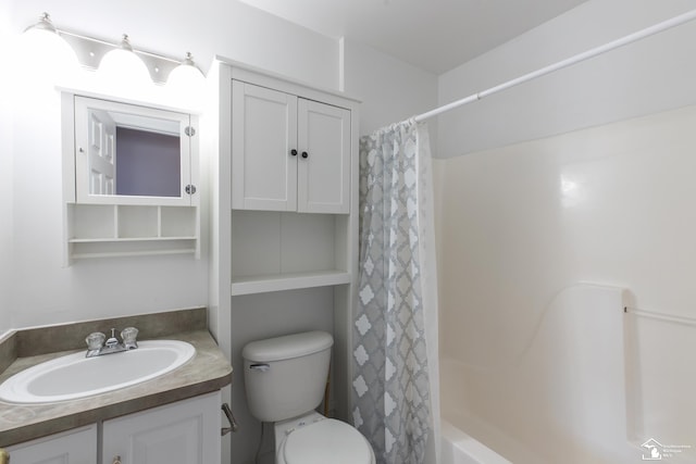 full bath featuring shower / bath combination with curtain, toilet, and vanity