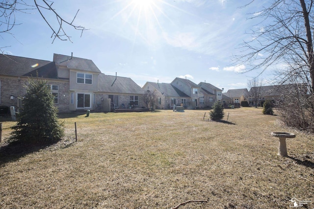 view of yard featuring central AC unit and a residential view