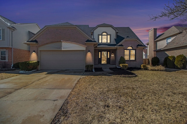 view of front of home featuring brick siding, concrete driveway, and a garage