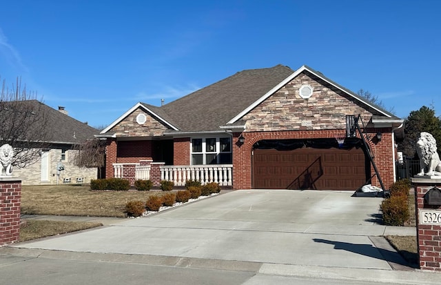 view of front of property featuring brick siding, roof with shingles, a garage, stone siding, and driveway