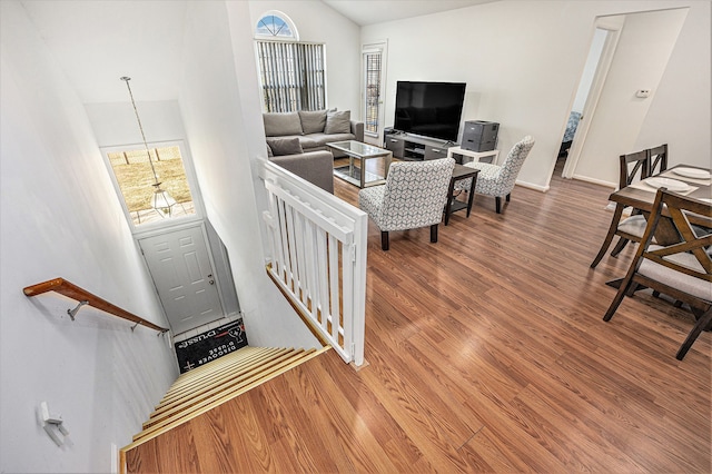 living room with high vaulted ceiling and wood finished floors