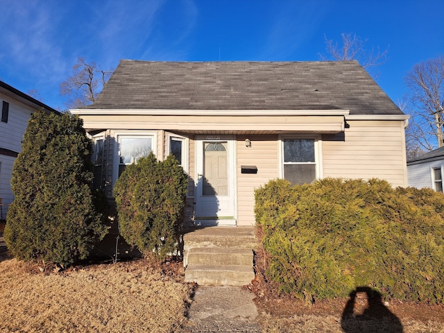 bungalow-style house with roof with shingles