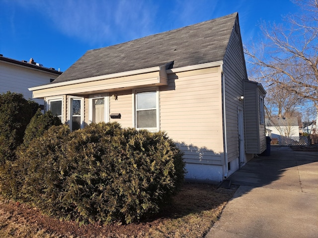 view of home's exterior featuring a shingled roof