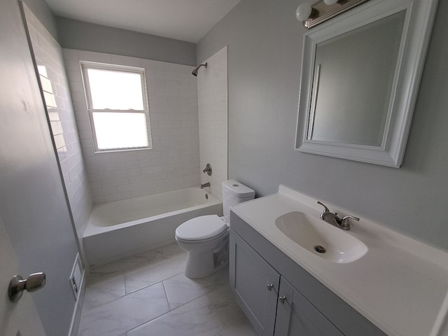 bathroom featuring marble finish floor, toilet, vanity, and washtub / shower combination