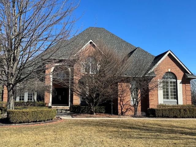 view of front of house featuring a front yard and brick siding